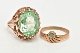 TWO YELLOW METAL RINGS, to include a large dress ring set with a pale green oval stone assessed as