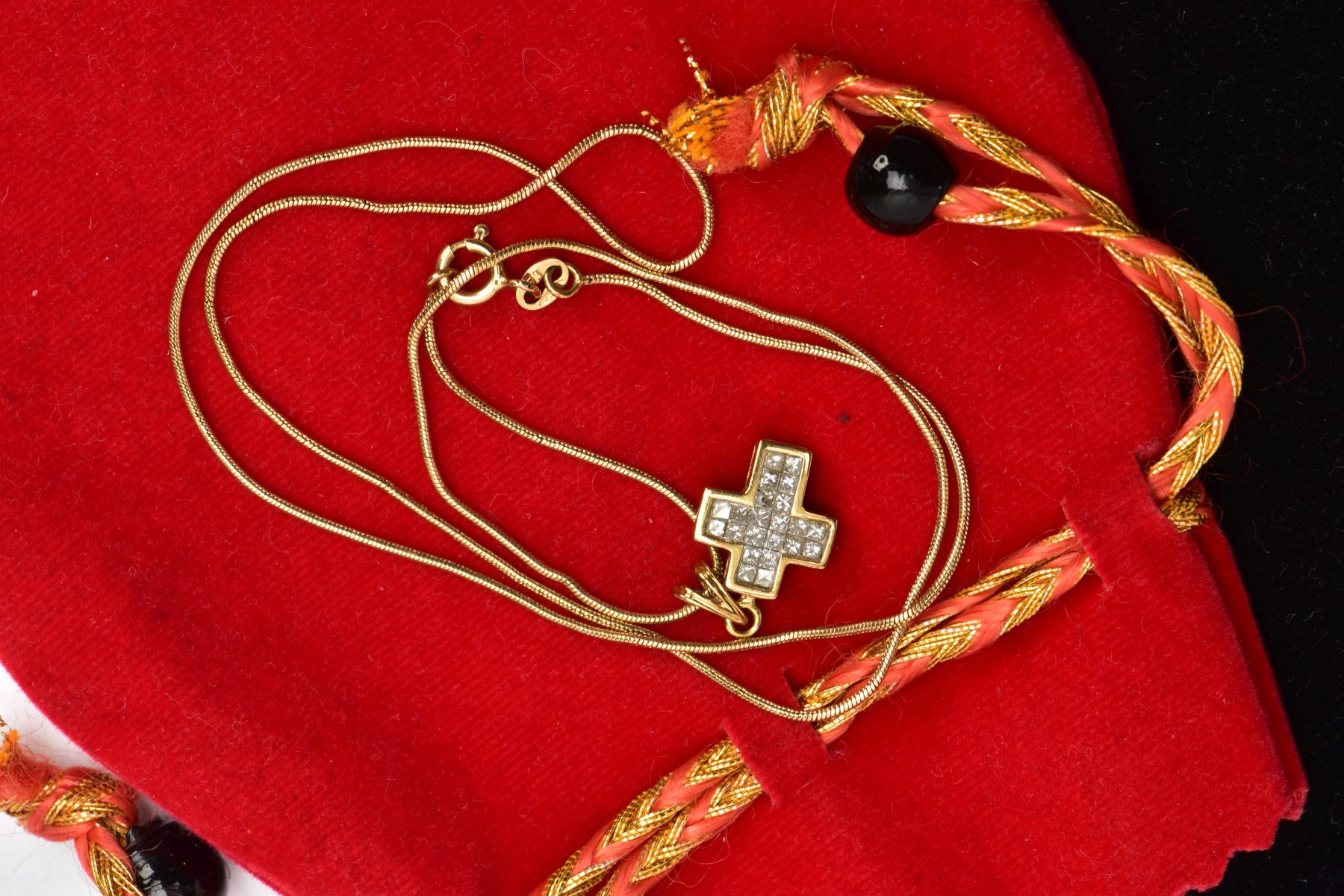 A YELLOW METAL DIAMOND CROSS PENDANT NECKLACE, the cross pendant set with princess cut diamonds,