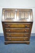 AN OAK LINENFOLD BUREAU, with four drawers, width 77cm x depth 42cm x height 105cm