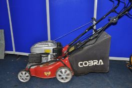 A COBRA PETROL LAWNMOWER with grass box (untested but pulling freely)