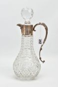 A SILVER MOUNTED GLASS CLARET JUG, Bacchus face to the collar, fitted with a scrolling handle