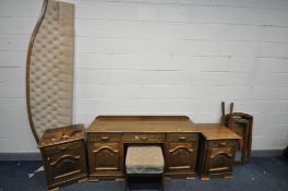 AN OAK DRESSING TABLE, with three drawers over two cupboards doors, and triple mirrors width 152cm x