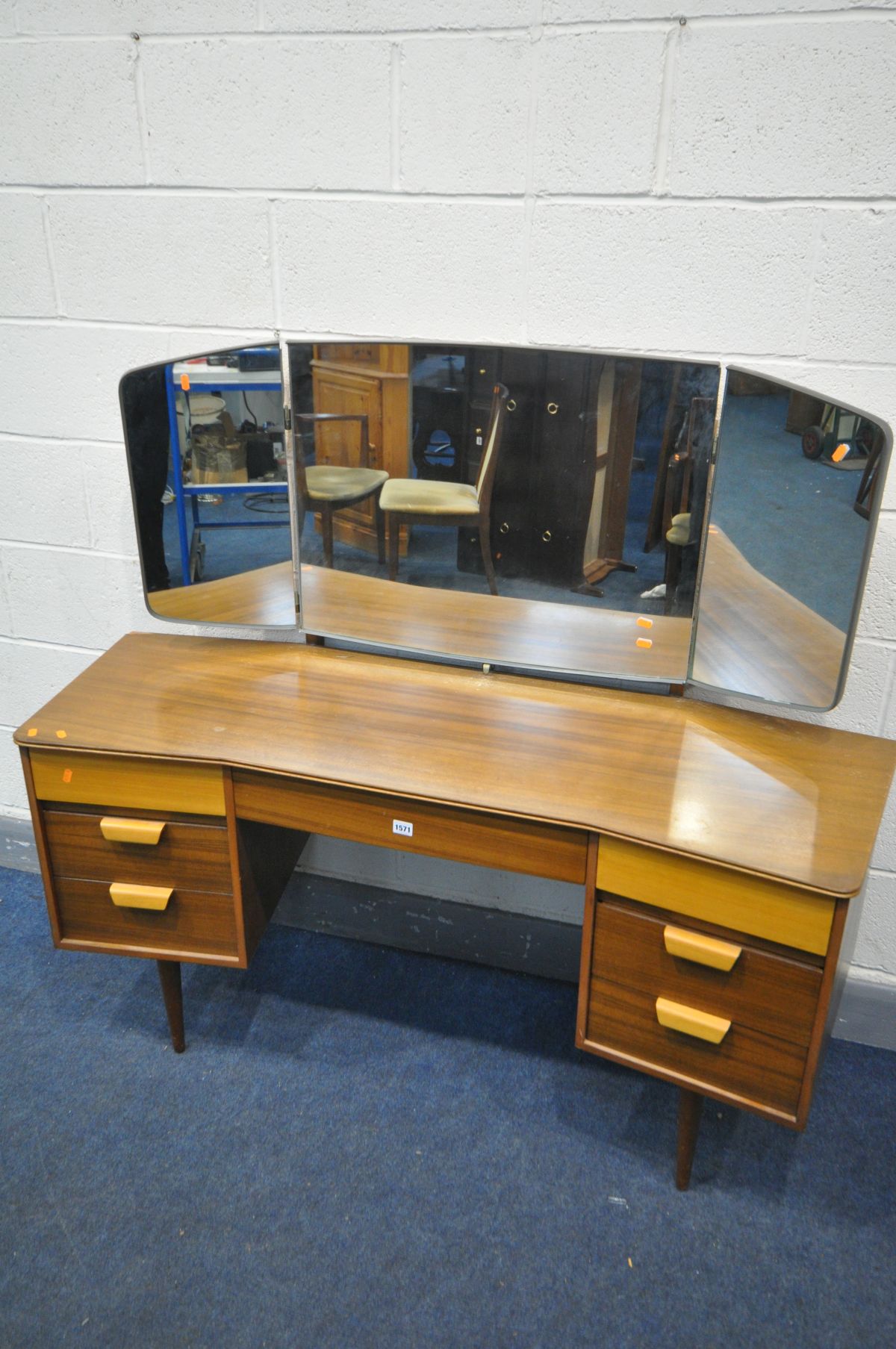 A UNIFLEX TEAK DRESSING TABLE, with triple mirror, and seven drawers, width 146cm x depth 56cm x