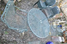 A TUBULAR STEEL GARDEN TABLE with mesh top, 106cm in diameter, four matching chairs, a set of six