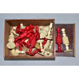 A LATE 19TH CENTURY TURNED AND STAINED IVORY CHESS SET, sixteen of each colour (red and natural),