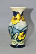 A MOORCROFT POTTERY PANSY PARADE BALUSTER VASE, having tubelined yellow and purple pansies on a