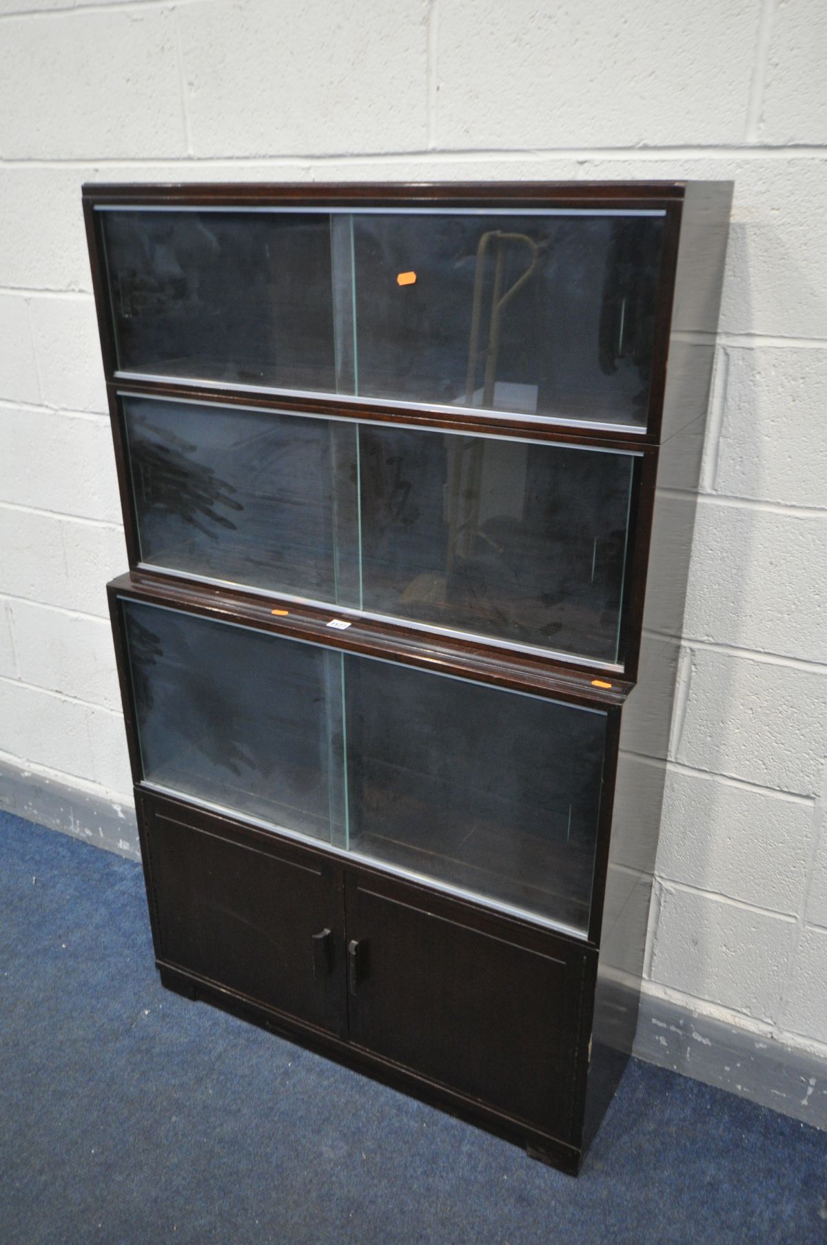 A MINTY MAHOGANY FOUR SECTION BOOKCASE, the top three sections with glazed doors, the bottom section