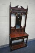 A REPRODUCTION MAHOGANY HALL STAND, with four brass hooks, central mirror, and two drawers, width