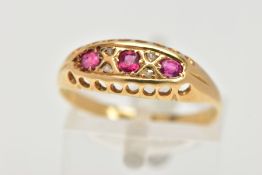 A YELLOW METAL RUBY BOAT RING, three circular cut rubies, prong set with four old cut diamonds in