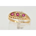 A YELLOW METAL RUBY BOAT RING, three circular cut rubies, prong set with four old cut diamonds in