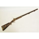 AN ANTIQUE 12 BORE SINGLE BARREL PERCUSSION SHOTGUN, its metal surfaces are heavily rusted, and