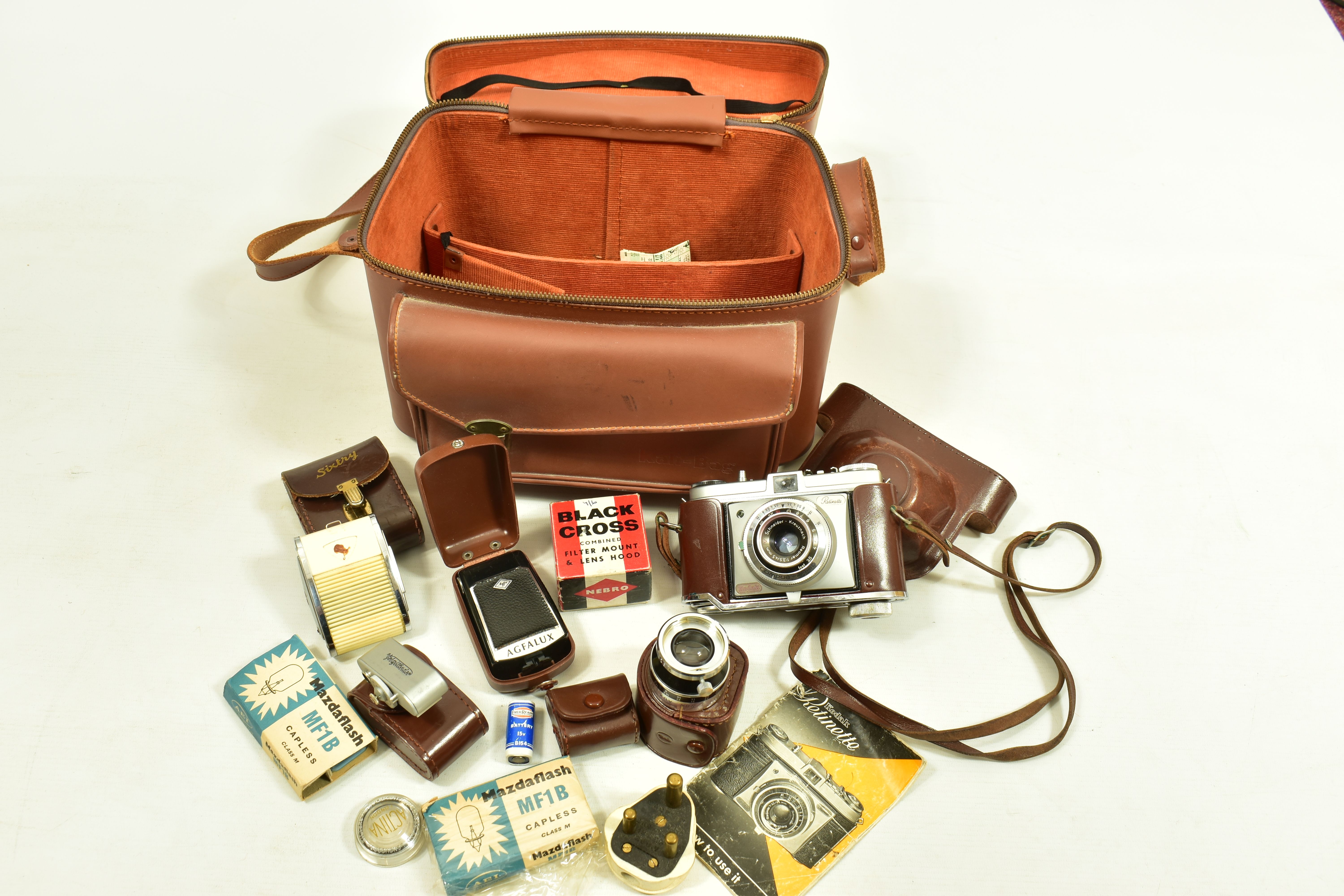 A CAMERA BAG CONTAINING A KODAK RETINETTE FILM CAMERA, a Sun tele converter, Voigtander Rangefinder,