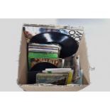 A TRAY CONTAINING OVER SEVENTY LPs, EPs AND SINGLES by artists such as The Beatles, John Lennon,