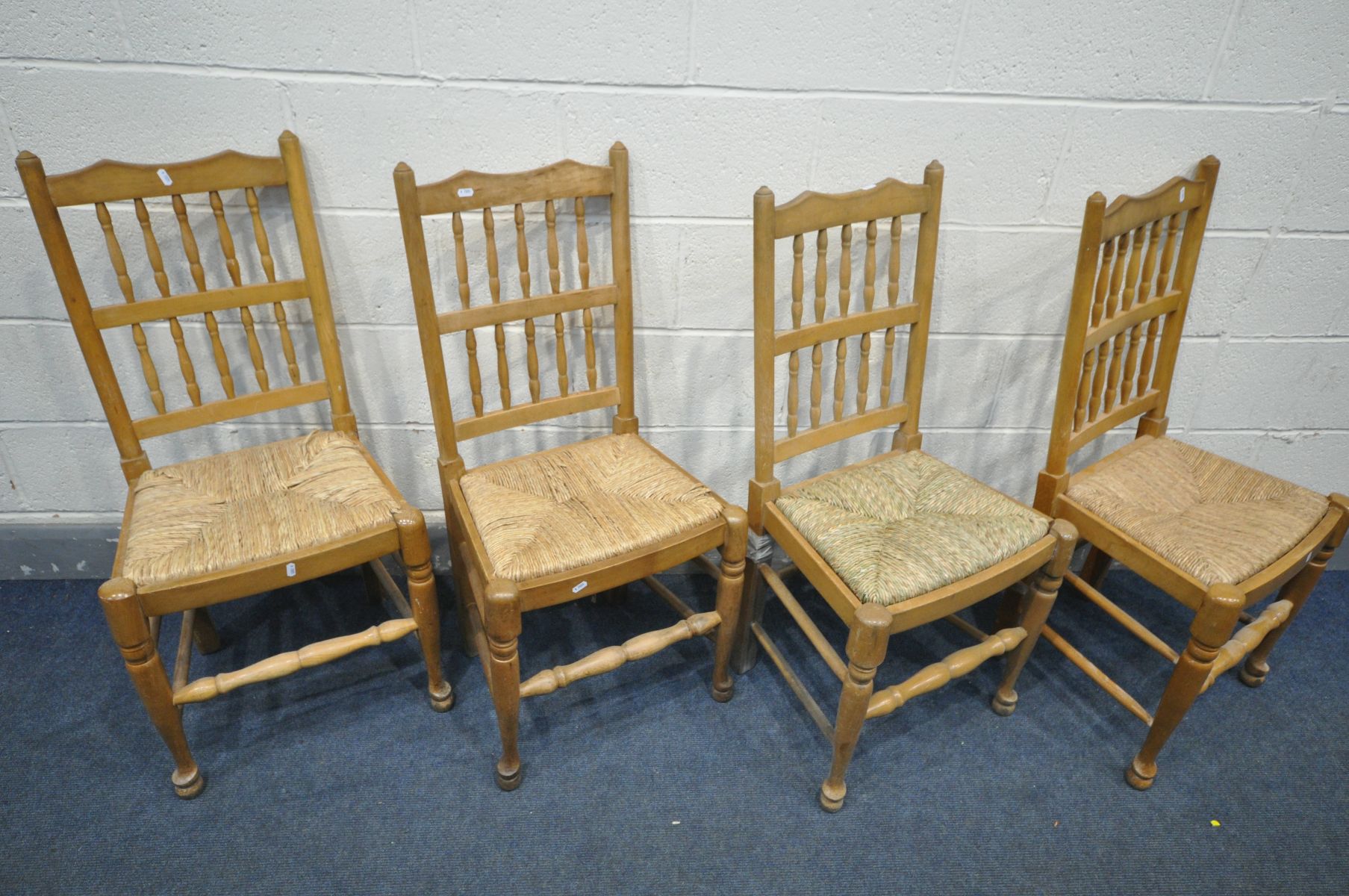 A HARLEQUIN SET OF FOUR BEECH LANCASHIRE DINING CHAIRS, with rush drop in seat pads (condition:-