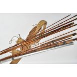 THREE HARDY SPLIT CANE FISHING RODS, fishing reel, canvas rod bags and an aluminium rod case,
