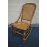 A 19TH CENTURY BEECH ROCKING CHAIR, with bergere back and seat (condition:- some faults and