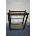 AN OAK UMBRELLA STAND, with six divisions and green enamal tray insert, width 53cm x depth 23cm x