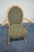 AN ERCOL WINDSOR ELM ROCKING, model 315, with military green seat and back cushions (the chair