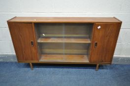 A MID-CENTURY TEAK BOOKCASE, with two cupboard doors flanking a glazed double door section, on