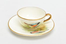 A ROYAL WORCESTER MINIATURE CUP AND SAUCER, the ivory ground painted with a Redstart to the cup