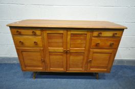 A 1950'S ERCOL ELM SIDEBOARD, with an arrangement of drawers, and cupboard doors, on turned legs