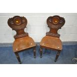 A PAIR OF WILLIAM IV MAHOGANY HALL CHAIRS, the back with ribbon decoration, on fluted front legs
