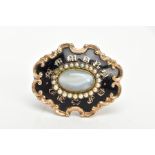 A MID VICTORIAN MOURNING BROOCH, gold-plated oval design, black enamel with the words 'In Memory Of'
