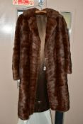 A LADIES THREE QUARTER LENGTH BROWN FUR COAT, possibly musquash