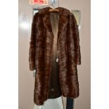 A LADIES THREE QUARTER LENGTH BROWN FUR COAT, possibly musquash