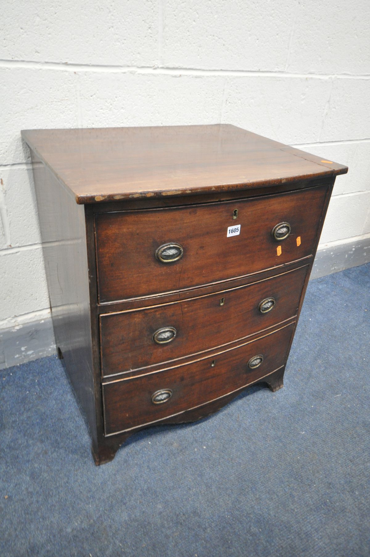 A SMALL GEORGIAN MAHOGANY BOW FRONT CHEST OF THREE DRAWERS, width 62cm x depth 49cm x height 70cm (