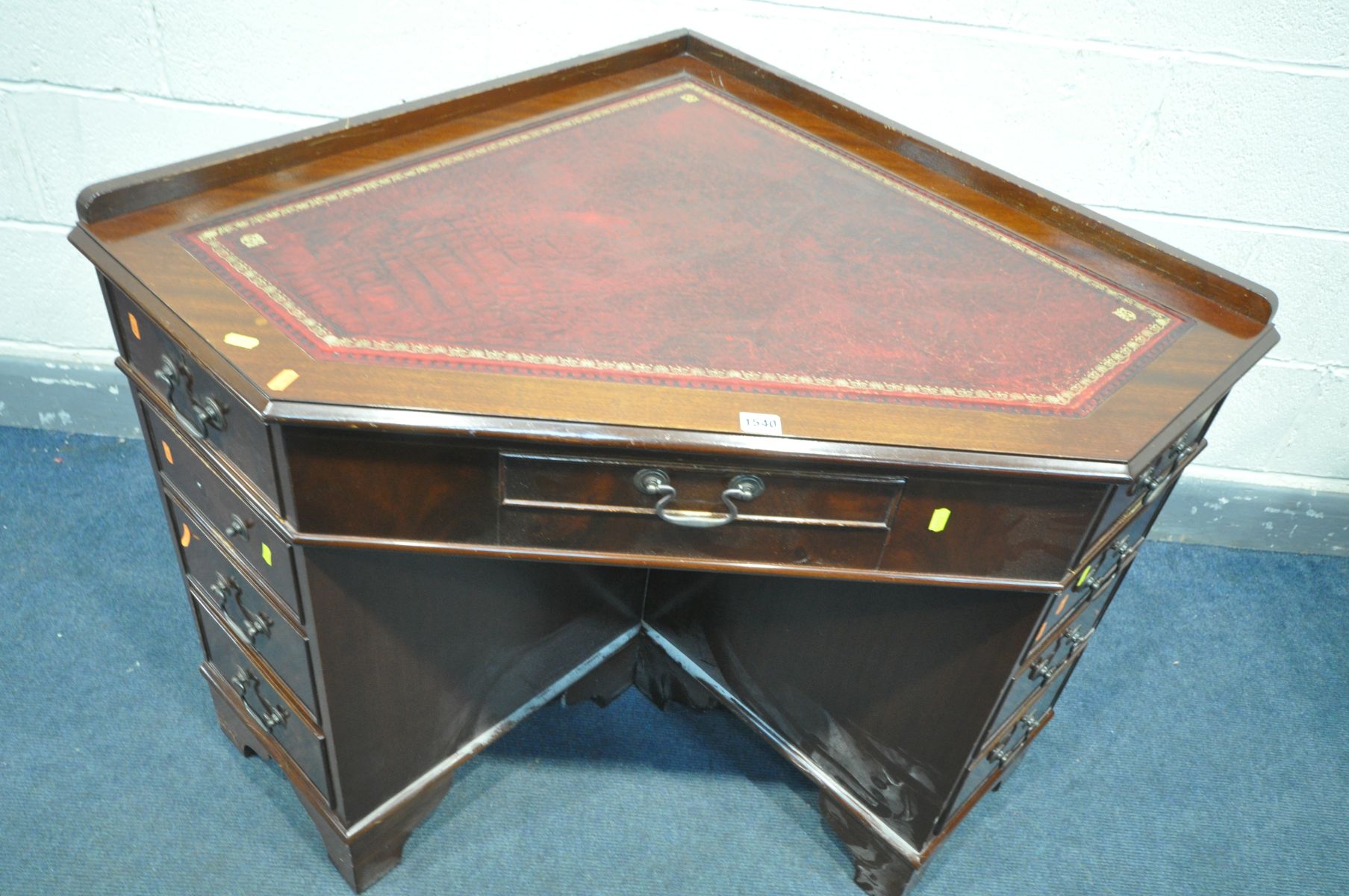 A MAHOGANY CORNER PEDESTAL DESK, with a burgundy leather and gilt tooled inlay top, and an