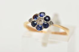 A YELLOW METAL DIAMOND AND SAPPHIRE CLUSTER RING, of a flower design, set with a central single