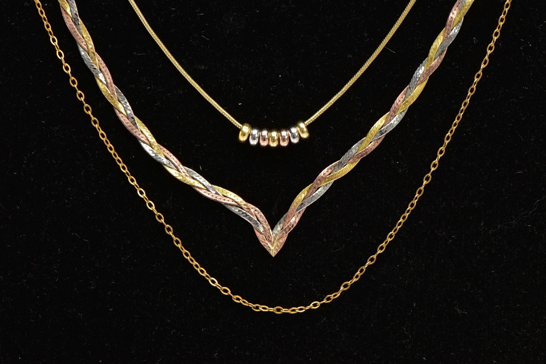 THREE 9CT GOLD NECKLACES, the first a tri-colour plaited V-shape chain fitted with a spring clasp