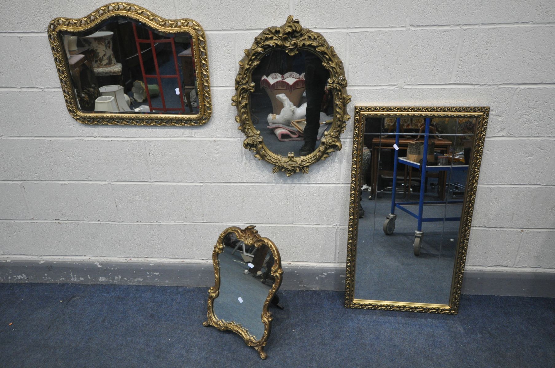FOUR VARIOUS GILT FRAMED MIRRORS, to include an oval rococo style wall mirror, two other wall