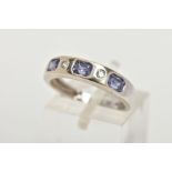 A 9CT WHITE GOLD HALF ETERNITY RING, designed with a row of three rectangular cut light purple cubic