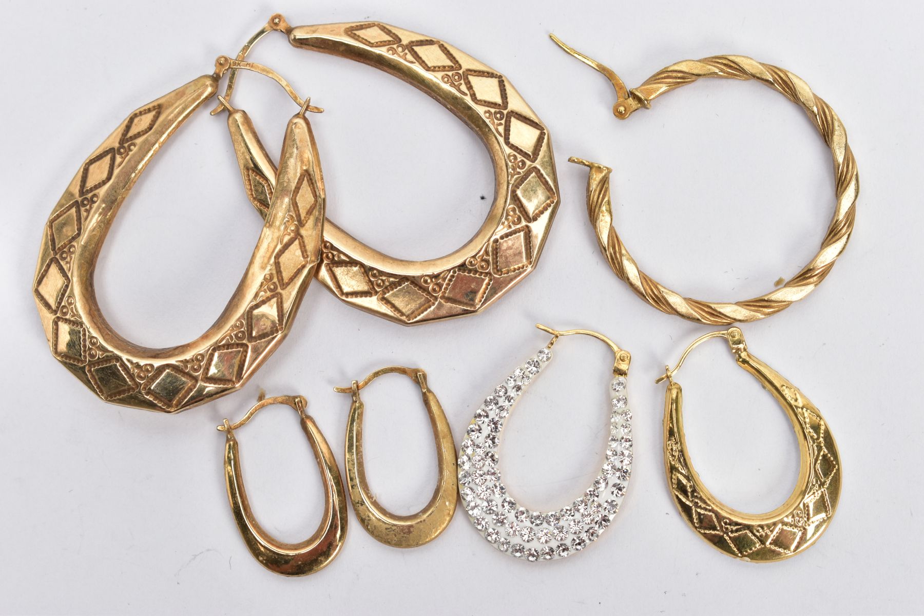 THREE PAIRS OF HOOP EARRINGS AND A SINGLE EARRING, to include a large pair of oval drop hoop