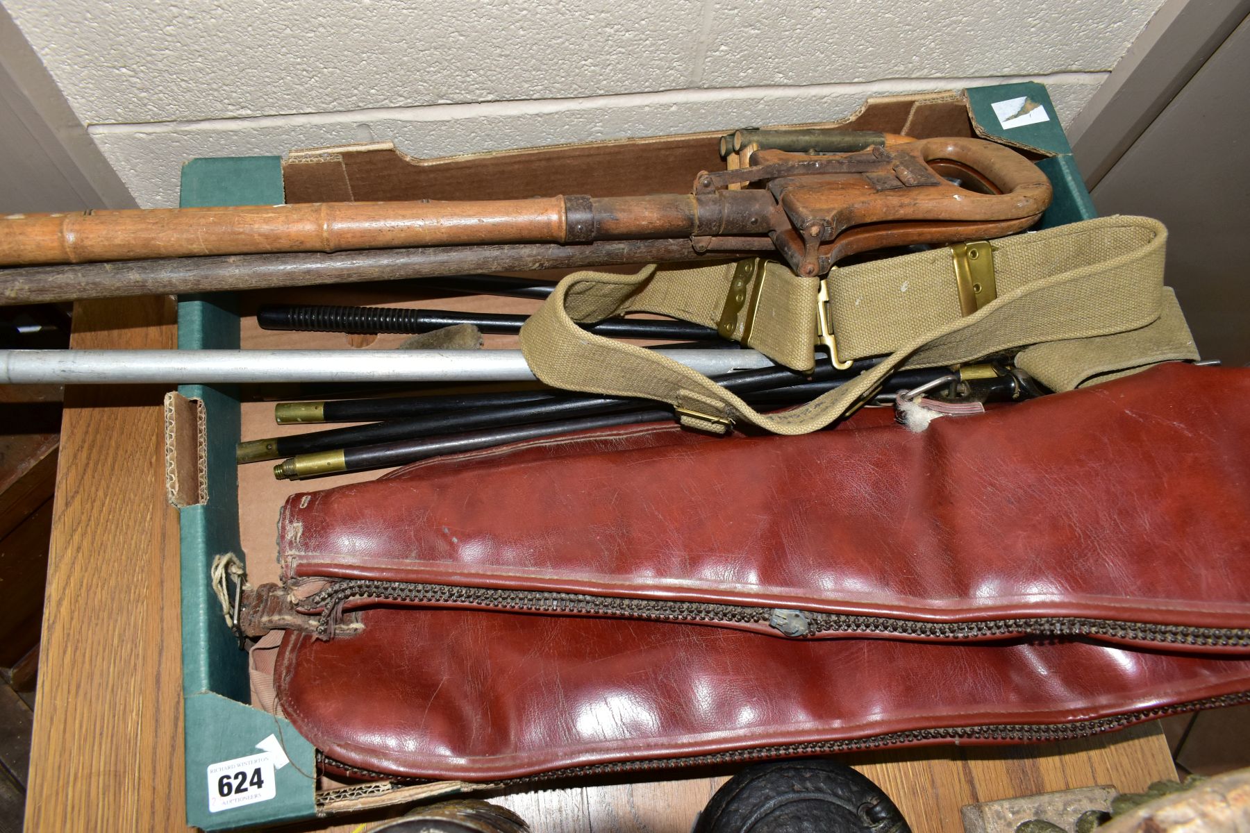 A BOX OF SHOOTING RELATED ITEMS, to include three hardwood two part gun cleaning rods with fittings,