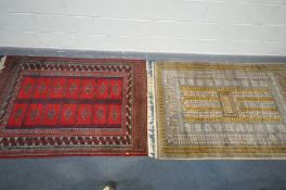 TWO 20TH CENTURY WOOLLEN RUG, one with red field, 186cm x 124cm, and a the other russet field, 198cm