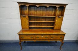 A GOOD REPRODUCTION OAK DRESSER, the top with an arrangement of shelves and two cupboard doors, over