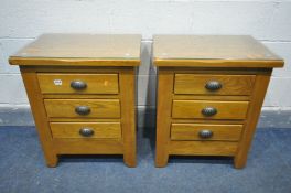 A PAIR OF SOLID OAK THREE DRAWER BEDSIDE CABINET, with loose glass protectors, width 55cm x depth