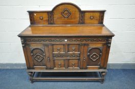 AN EARLY 20TH CENTURY OAK SIDEBOARD, with a raised back, two cupboard doors flanking two drawers, on