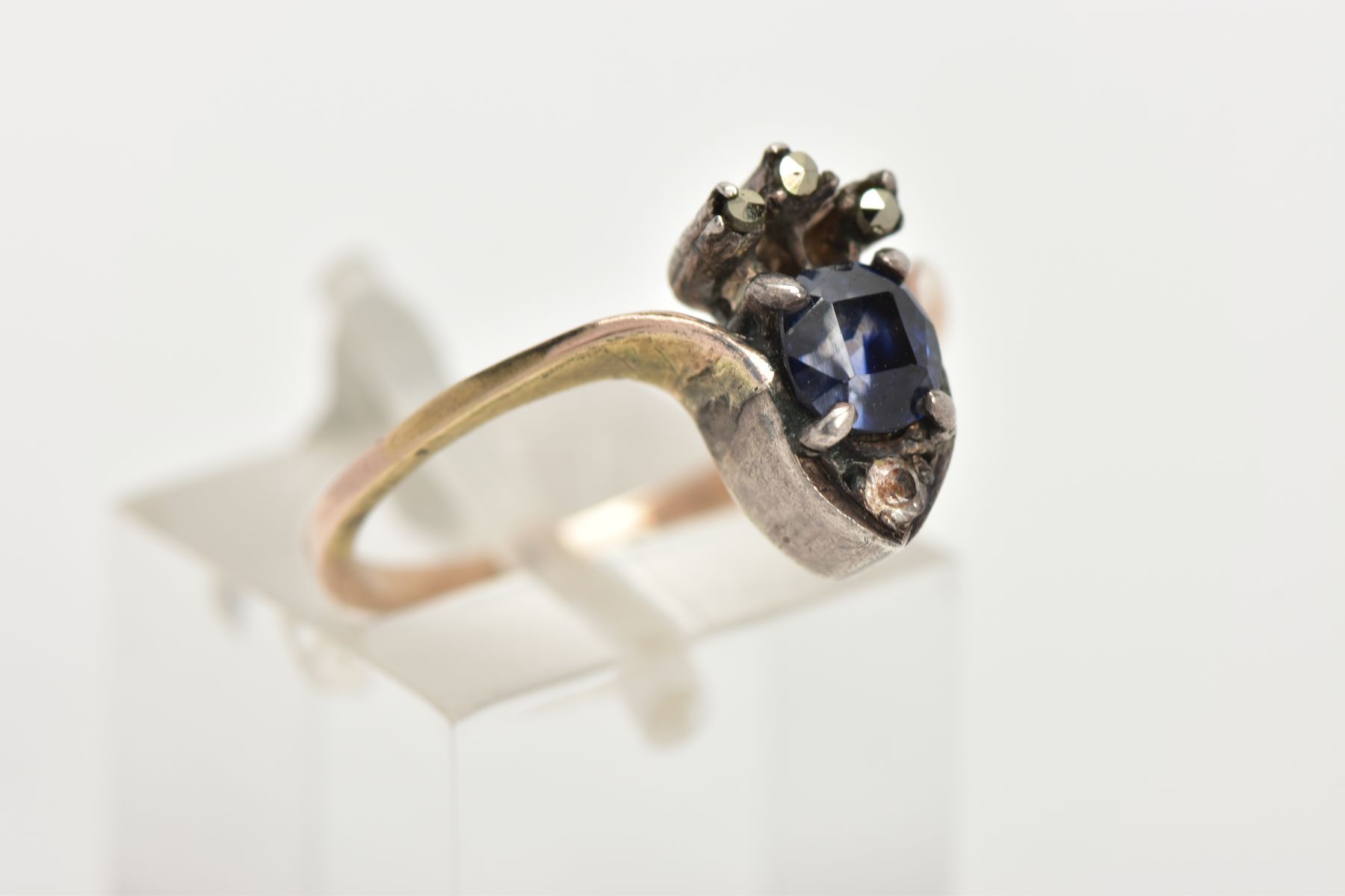 A YELLOW METAL RING, designed as a crown set with a central cushion cut blue stone, with marcasite - Image 4 of 4