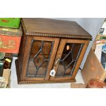 AN OAK SMOKERS CABINET, lacks tobacco jar and key, approximate dimensions - height 29cm, width 31cm,