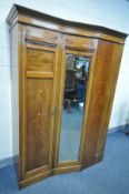 AN EDWARDIAN MAHOGANY AND INLAID WARDROBE, central angled proportions, with two glazed doors,