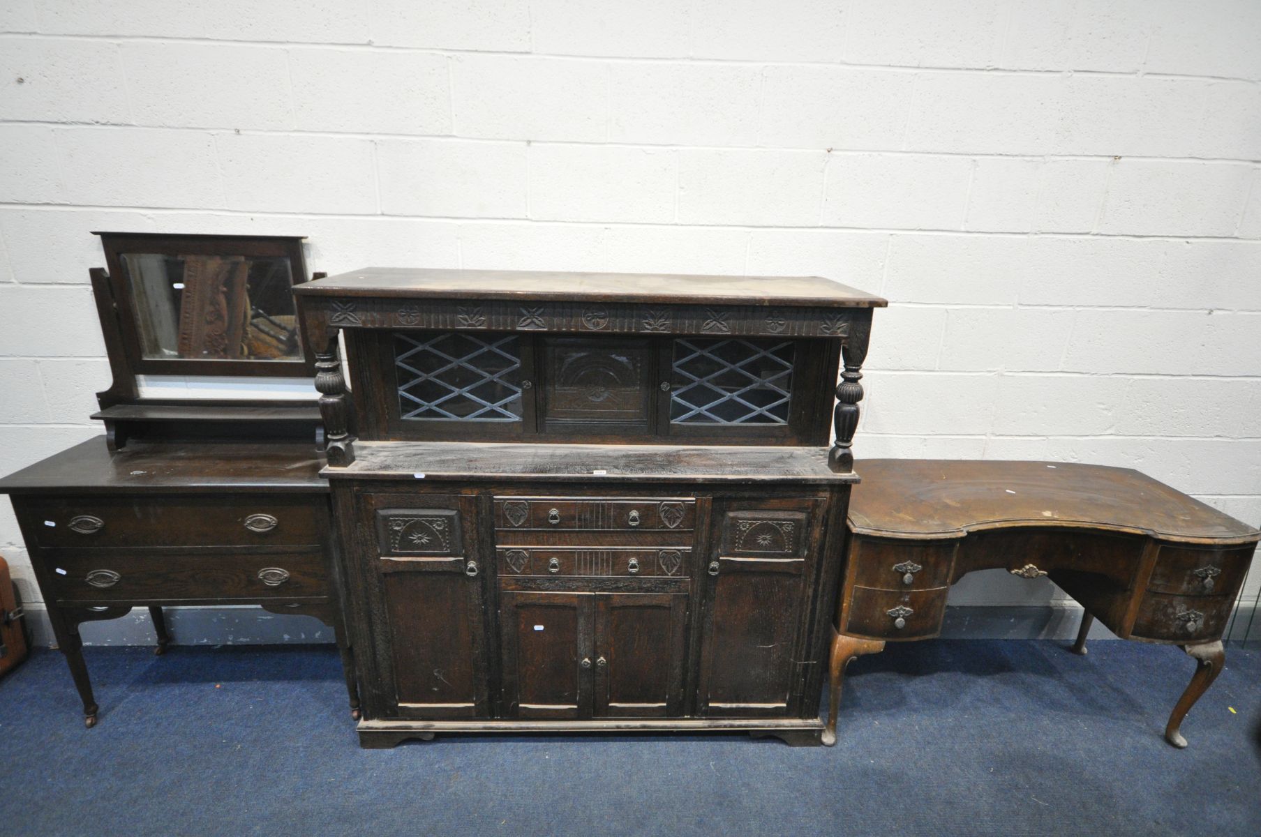 AN OAK COURT CUPBOARD, with an arrangement of cupboard doors and drawers, width 141cm x depth 47cm x