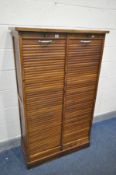 AN EARLY 20TH CENTURY OAK TWIN TAMBOUR FRONT FILING CABINET, enclosing a later altered arrangement