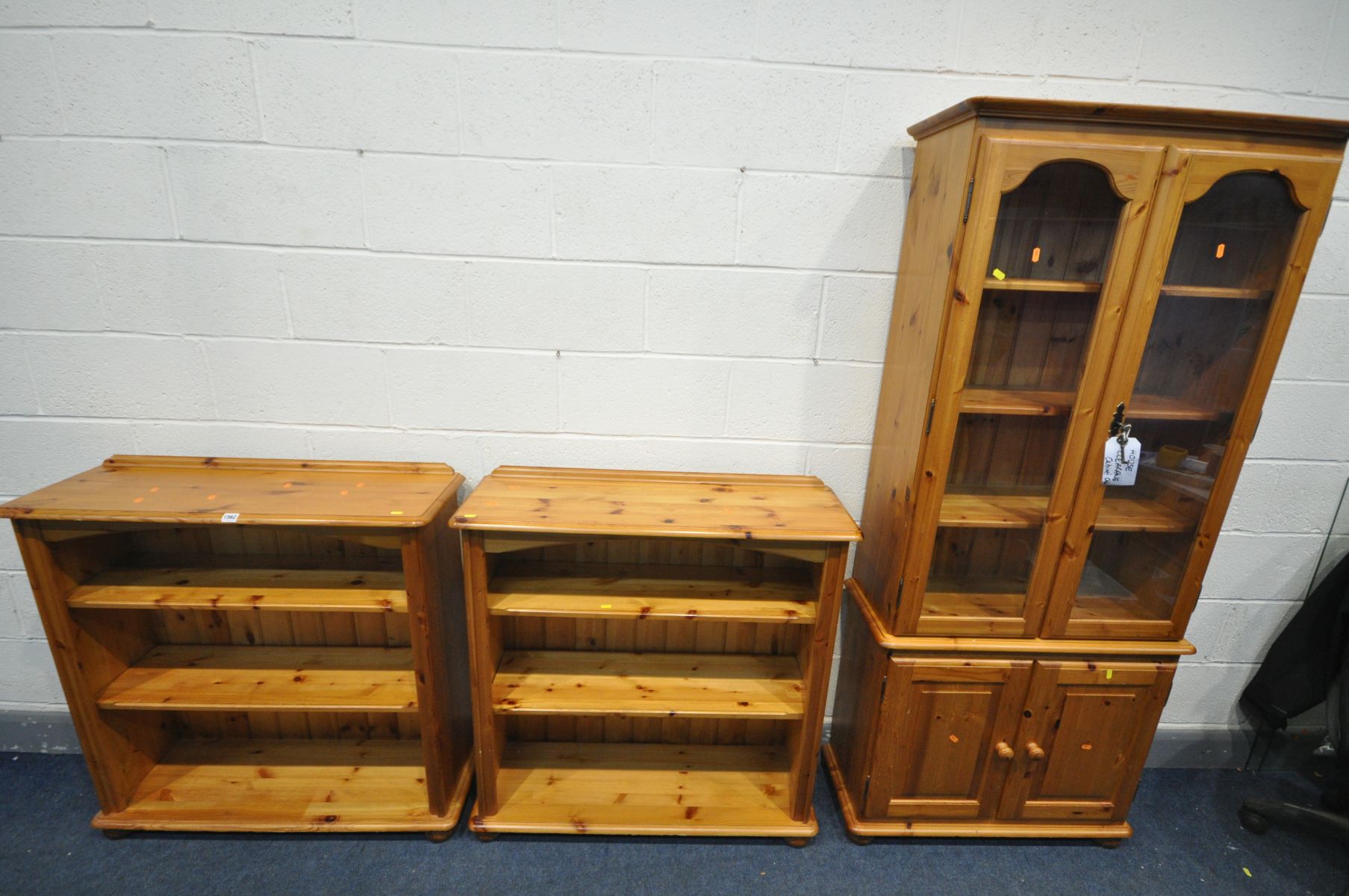 A MODERN PINE GLAZED DOUBLE DOOR BOOKCASE, width 82cm x depth 33cm x height 186c (two keys) along