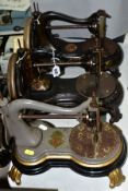 THREE ANTIQUE JONES CAST IRON SEWING MACHINES, hand cranked mechanism, with gilt or painted