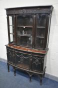 AN EARLY 20TH CENTURY FRENCH BOW FRONT DISPLAY CABINET, decorated with various foliate blind