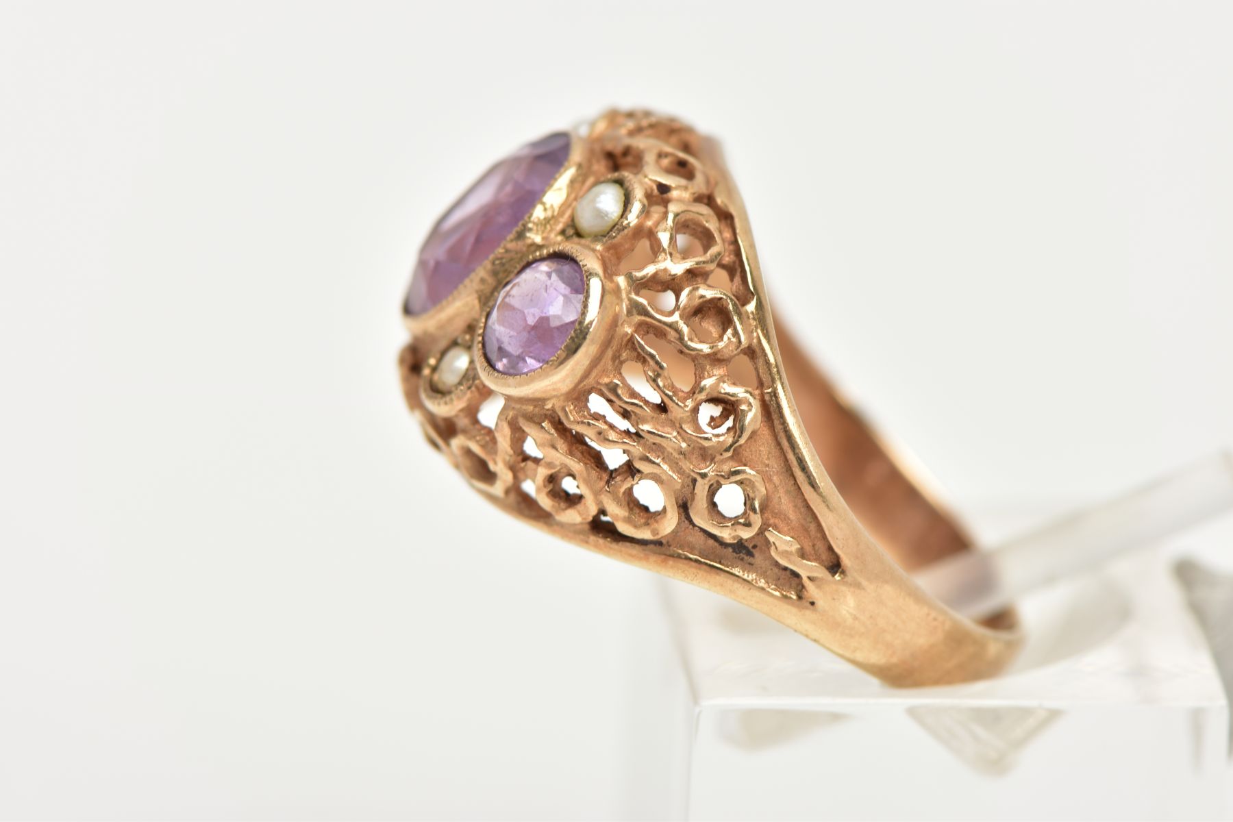 A YELLOW METAL AMETHYST AND SEED PEARL DRESS RING, centring on an oval cut amethyst milgrain - Image 2 of 4